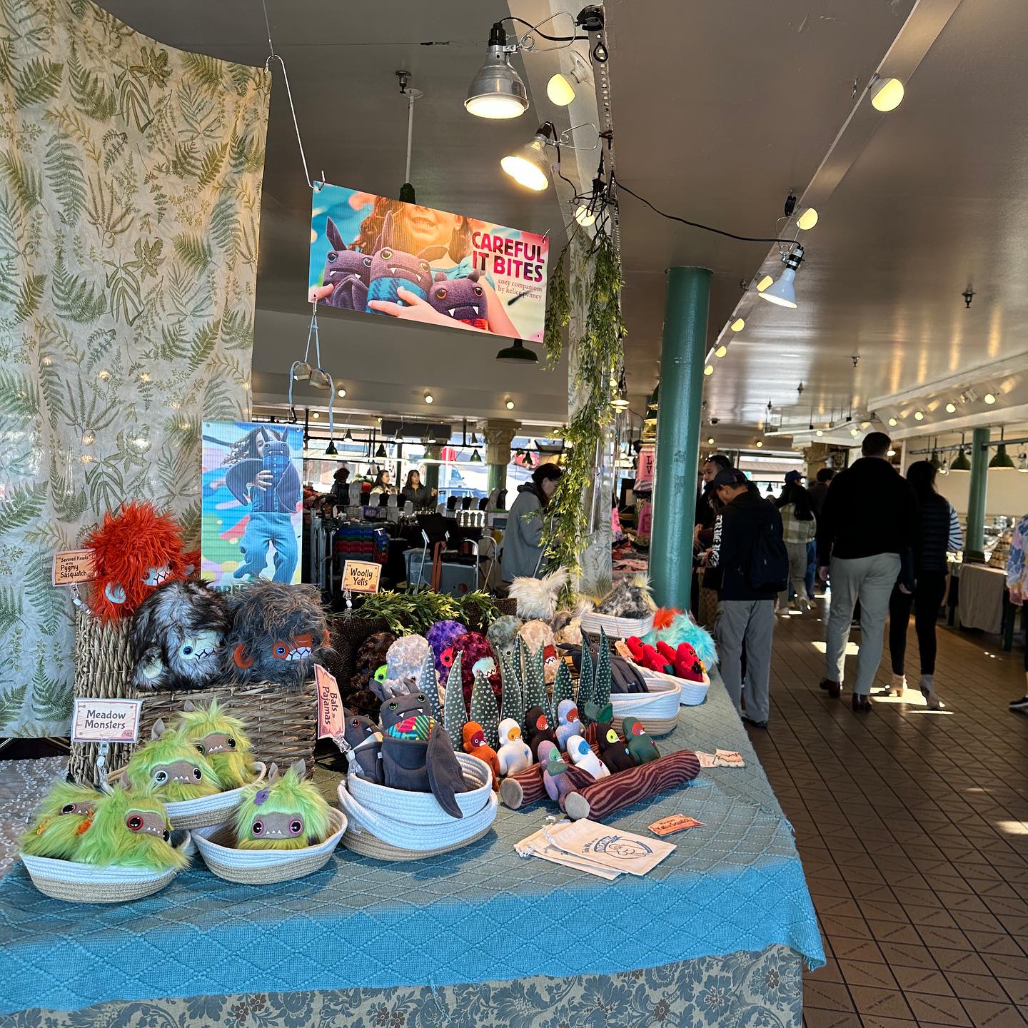 A colorful booth of plush animals set uip at pike place market.