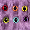Slit pupil safety eyes in six colors lay atop purple faux fur.