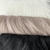 An  closeup array of faux fur in neutral tones of white grey and black