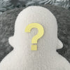 A white fleece figure with a question mark where its face should be sits in front of textures white background.